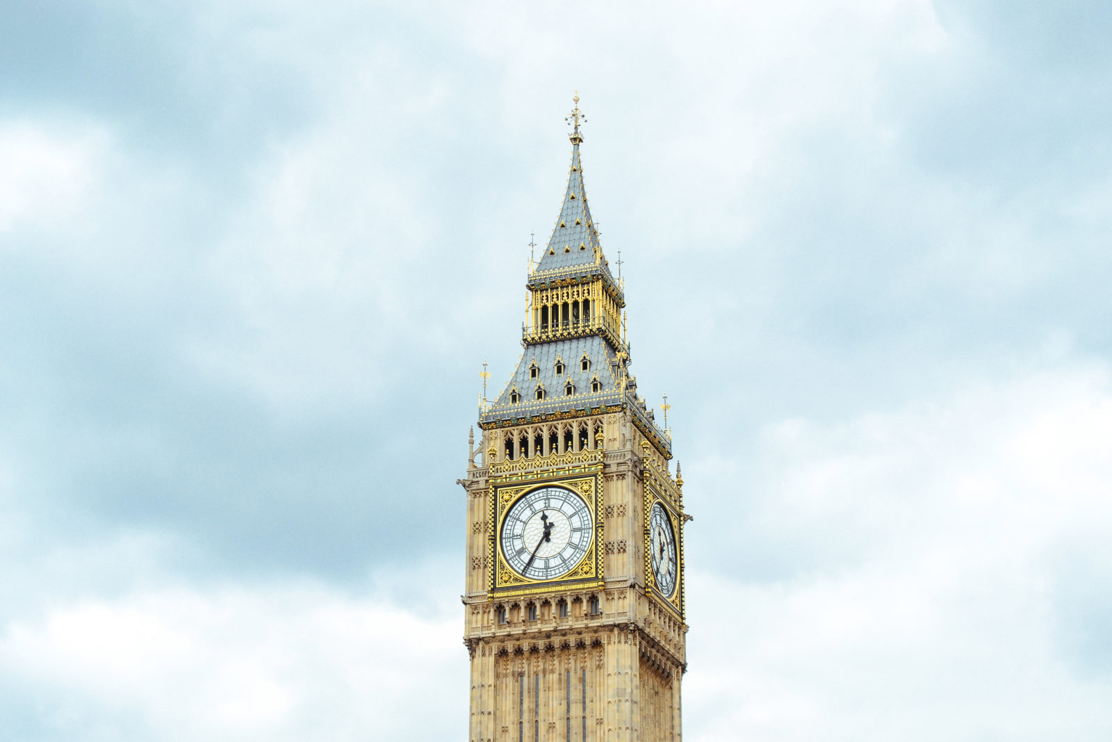 Iconic clock tower known as Big Ben in London under a cloudy sky.